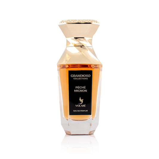 Perfume bottle with gold cap and clear body on a white background